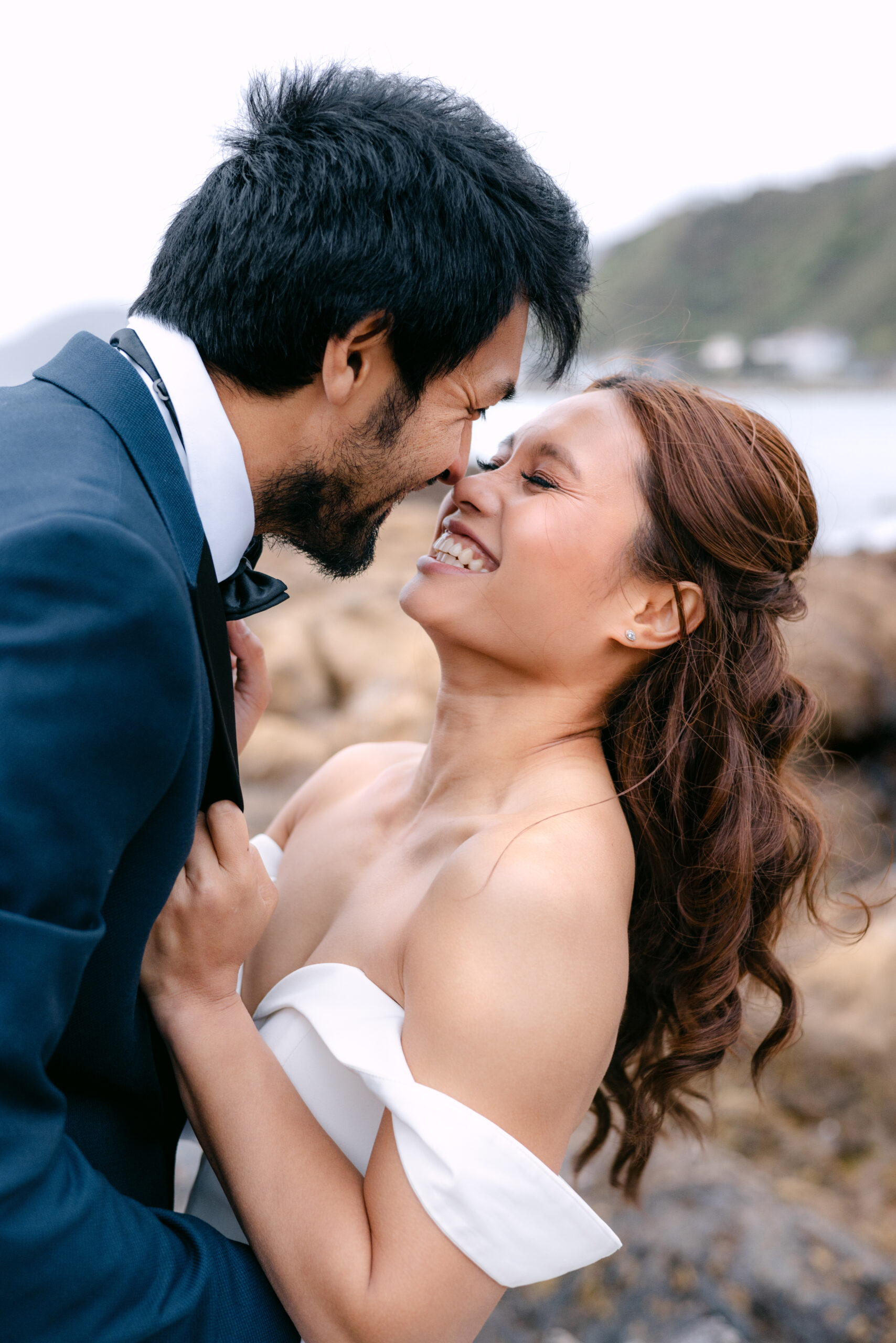 Ezra & Louie hugging during their wedding photoshoot with Wellington Wedding Photographer Lysanah Maguire at Princess Bay