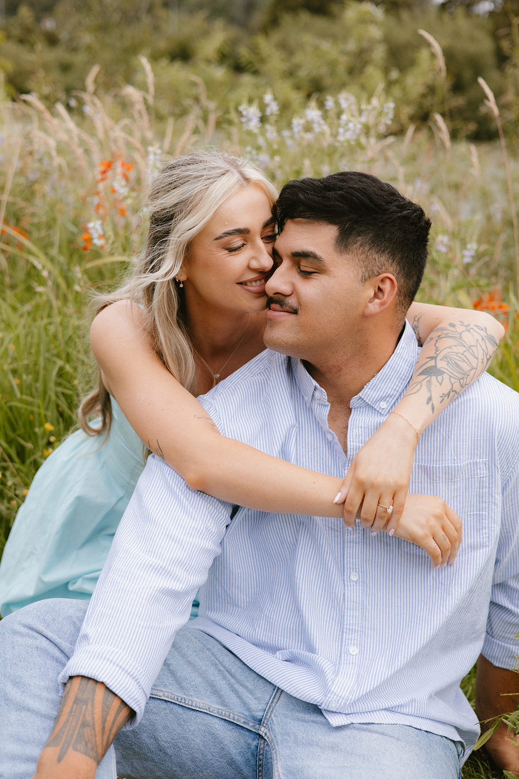 Ellie and Charli embracing outdoors during their Palmerston North engagement session.