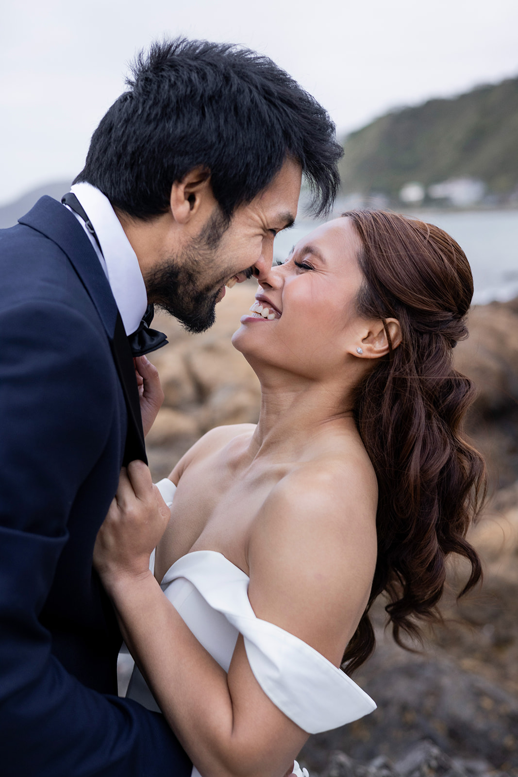 Ezra & Louie hugging during their wedding photoshoot with Wellington Wedding Photographer Lysanah Maguire at Princess Bay