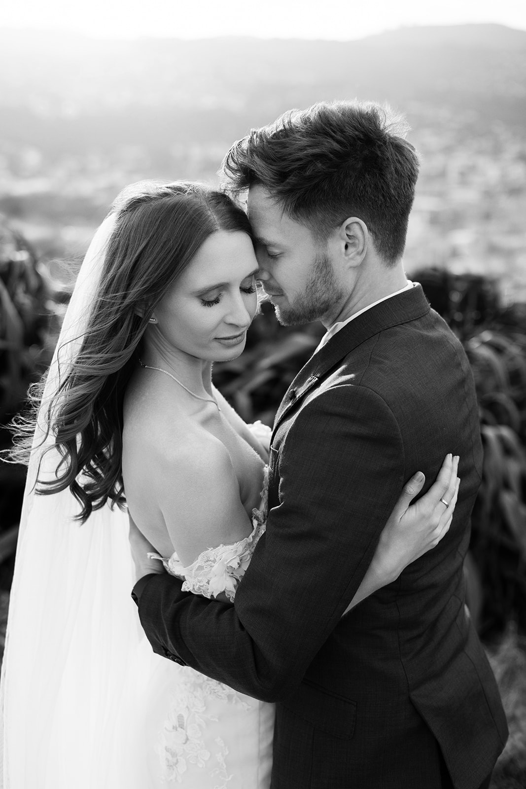 Black and white wedding portrait of Jade and Tyler standing close together in Wellington.